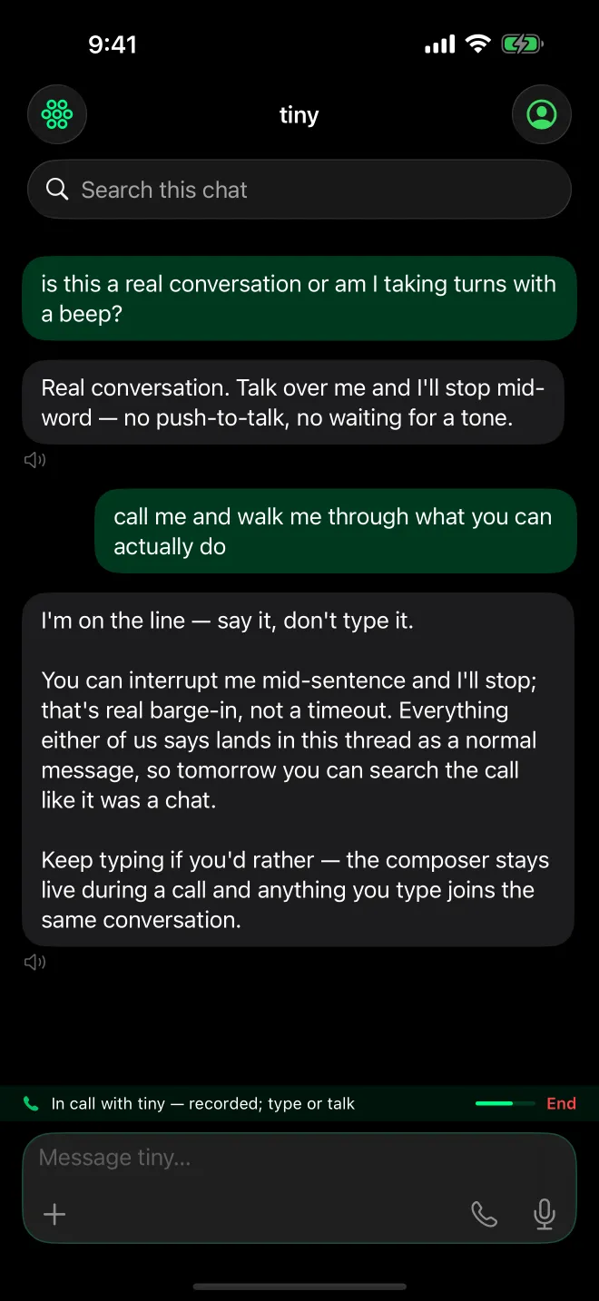 A live call with tiny on an iPhone: the transcript reads “Real conversation. Talk over me and I’ll stop mid-word — no push-to-talk, no waiting for a tone.”